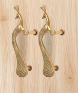 Golden brass peacock door handle pair with curved bodies and cylindrical lever grips