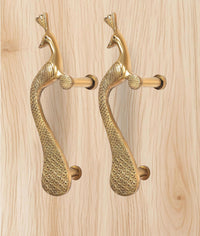 Golden brass peacock door handle pair with curved bodies and cylindrical lever grips