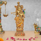 Brass Krishna idol with flute, peacock feather, and colorful Meenakari work