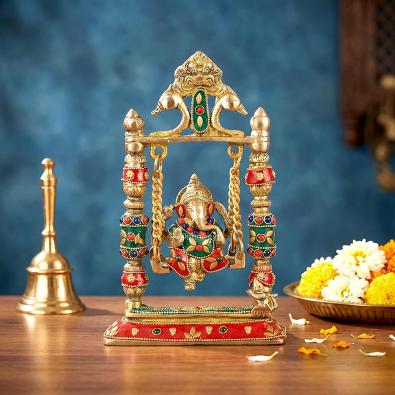 Brass Ganesha swing jhula showpiece with seated deity on golden swing frame