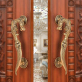 Brass yali design door handle pair with decorative curved lever and round backplate