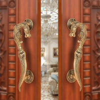 Brass yali design door handle pair with decorative curved lever and round backplate
