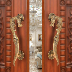 Brass yali design door handle pair with decorative curved lever and round backplate