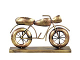 Gold iron bike statue on base, side view with handlebars and spoked wheels
