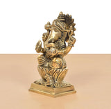 Brass Ganpati Bappa idol from the side, turned face and layered crown details