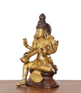 Side view brass Saraswati idol holding veena, gold skirt and sculpted base