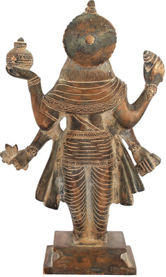 Brass Dhanvantari idol rear view, circular halo, patterned robes, raised arms.
