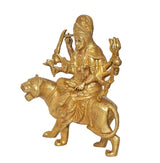 Gold brass Durga Maa on lion, side view, raised hands holding weapons