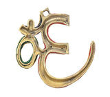 Brass OM wall hanging detail with red and teal jewel accents on curved edges