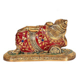 Brass lying Ganesha statue from back-left angle, red jeweled design on gold base