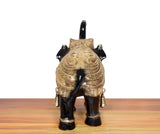 Brass elephant figurine, back view, gold back ornamentation and two bell charms