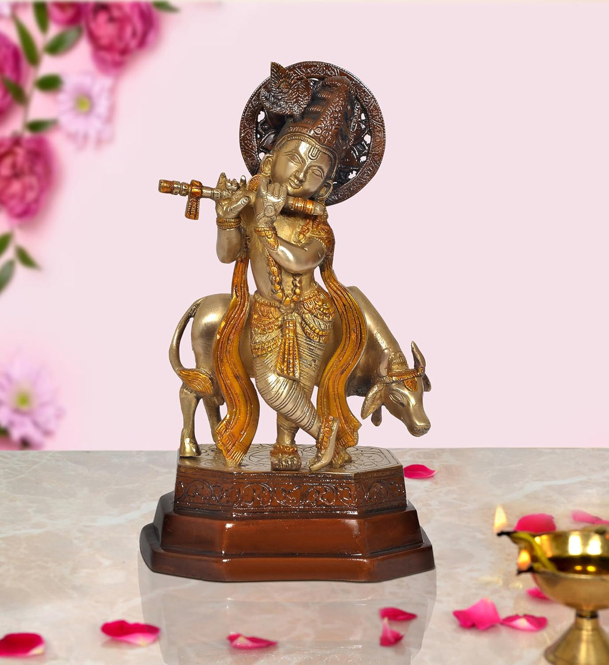 Brass Krishna idol standing on cow, playing flute, with ornate circular halo base