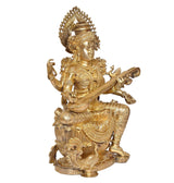 Brass Saraswati statue seated with veena, raised hand gestures, gold-toned details