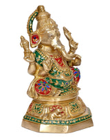 Brass Ganesh idol three-quarter view, gold body with green red and blue accents