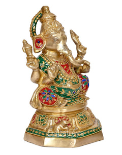 Brass Ganesh idol three-quarter view, gold body with green red and blue accents