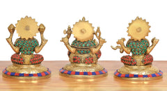 Rear view of brass Lakshmi, Ganesh and Saraswati idols showing painted backs and bases