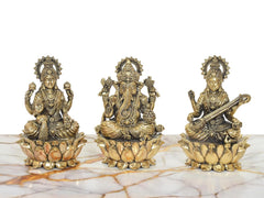 Brass three-deity idol set: Lakshmi left, Ganesha center, Saraswati right on lotus