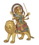 Brass Durga Maa idol with lion, front angle, multi-color skirt and halo with weapons
