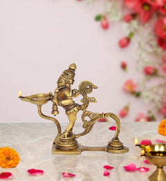 Brass Garun Aarti diya oil wick lamp with Garuda figure, lit flame