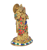 Brass Radha Krishna idol three-quarter view, detailed faces and jeweled robes on base
