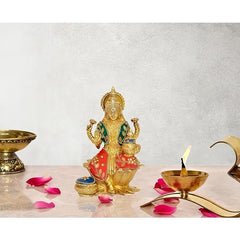 Brass Lakshmi statue seated on lotus, multicolor deity figurine