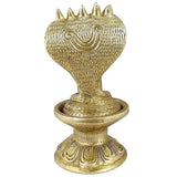 Close-up brass Shiva lingam statue with detailed cobra head canopy and patterned base