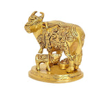 Golden brass cow with calf figurine, front three-quarter view on round base