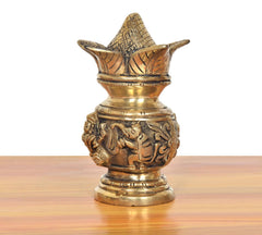 Brass kalash showpiece with detailed deity carvings on body and base, gold finish