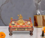 Brass Jyotirling chowki with seated Lord Shiva on decorated platform, red accents