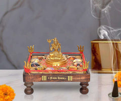 Brass Jyotirling chowki with seated Lord Shiva on decorated platform, red accents