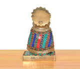 Rear view of brass Khatu Shyam idol with gem-studded robe and engraved back plate