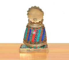Rear view of brass Khatu Shyam idol with gem-studded robe and engraved back plate