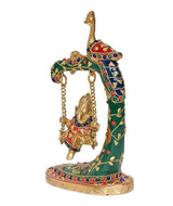 Side view of brass peacock swing Ganesh statue with jeweled multicolor decorations