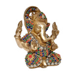 Brass Ganesha idol angled view with colorful gem-inlay crown and patterned robe