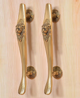 Gold brass door pull handles pair with lion face crest and fluted lower curve