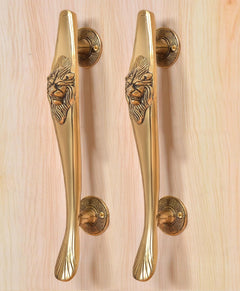 Gold brass door pull handles pair with lion face crest and fluted lower curve