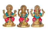 Front view of brass Lakshmi, Saraswati and Ganesha idols seated on golden bases