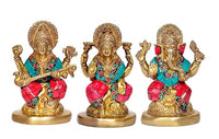 Front view of brass Lakshmi, Saraswati and Ganesha idols seated on golden bases