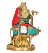Brass cow idol with Radha-Krishna, rear angle showing red-blue saddle and jewels