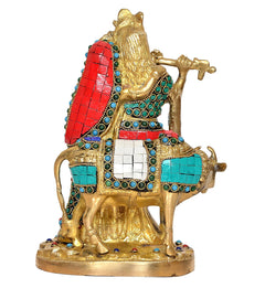Brass cow idol with Radha-Krishna, rear angle showing red-blue saddle and jewels