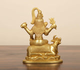 Back view of golden brass Shiva on Nandi statue, ornate detailing