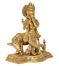 Krishna flute statue in brass tone, standing on cow with small figures, detailed base