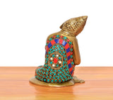 Brass Buddha idol rear view with multicolor patterned robe and jeweled details