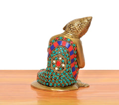 Brass Buddha idol rear view with multicolor patterned robe and jeweled details