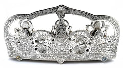 Silver metal sculpture side view with three deities and detailed floral relief canopy