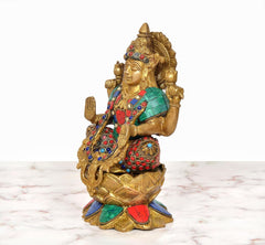 Brass Lakshmi idol seated on lotus, side profile, multicolored jewel ornaments