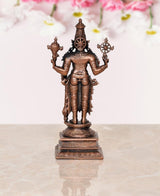 Copper Vishnu statue rear view, central crown and flanking wheel weapons on base