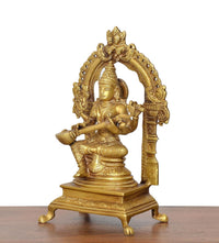 Side view brass Saraswati goddess idol holding veena, arched decorative back frame