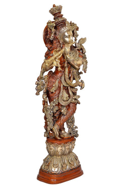 Back view Krishna brass statue with red garments and gold details, ornate crown