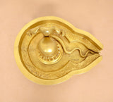Brass Shiva Ling murti tray detail with engraved leaf pattern and central ling